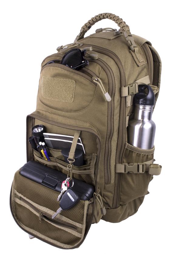 A fully-equipped Elite Survival Systems PULSE 24-Hour Backpack with various compartments containing items like sunglasses, a water bottle, and pens, isolated on a white background.