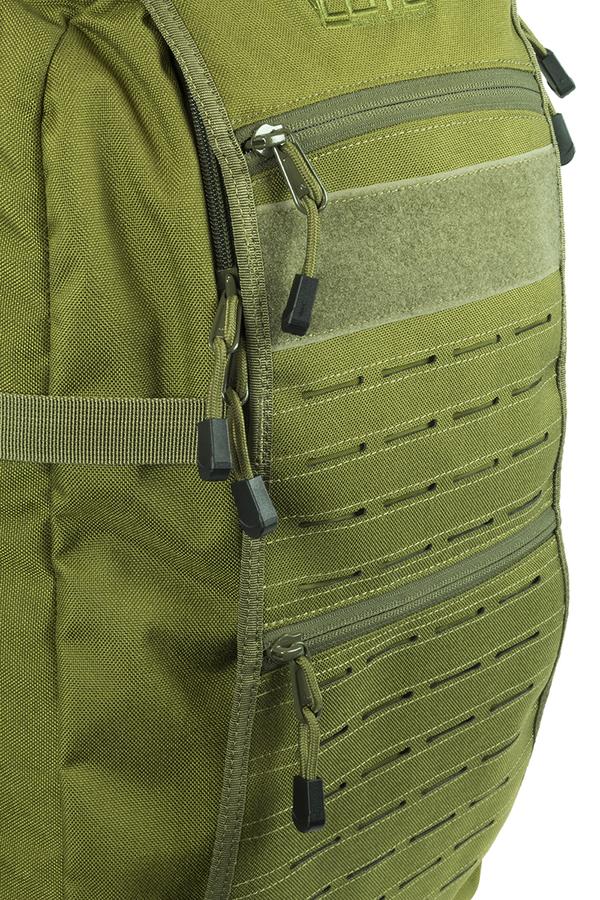 Close-up of a green Elite Survival Systems Mission Pack Backpack featuring multiple compartments with zipper closures and molle webbing for attaching gear.