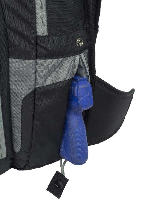 Close-up of a gray Elite Survival Systems Gen II Smokescreen Backpack with a blue whistle attached to a zipper.