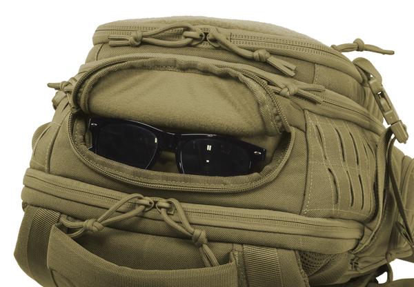 Elite Survival Systems Guardian EDC backpack with a pair of black sunglasses positioned on the top compartment, creating a face-like appearance.