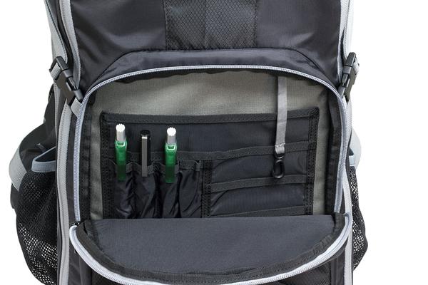 Open Elite Survival Systems STEALTH Covert Operations Backpack displaying internal storage compartments with two green pens in elastic loops.