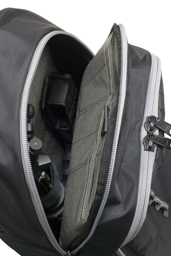 Open Elite Survival Systems Stealth Covert Operations backpack showcasing a DSLR camera and a lens, set against a white background.