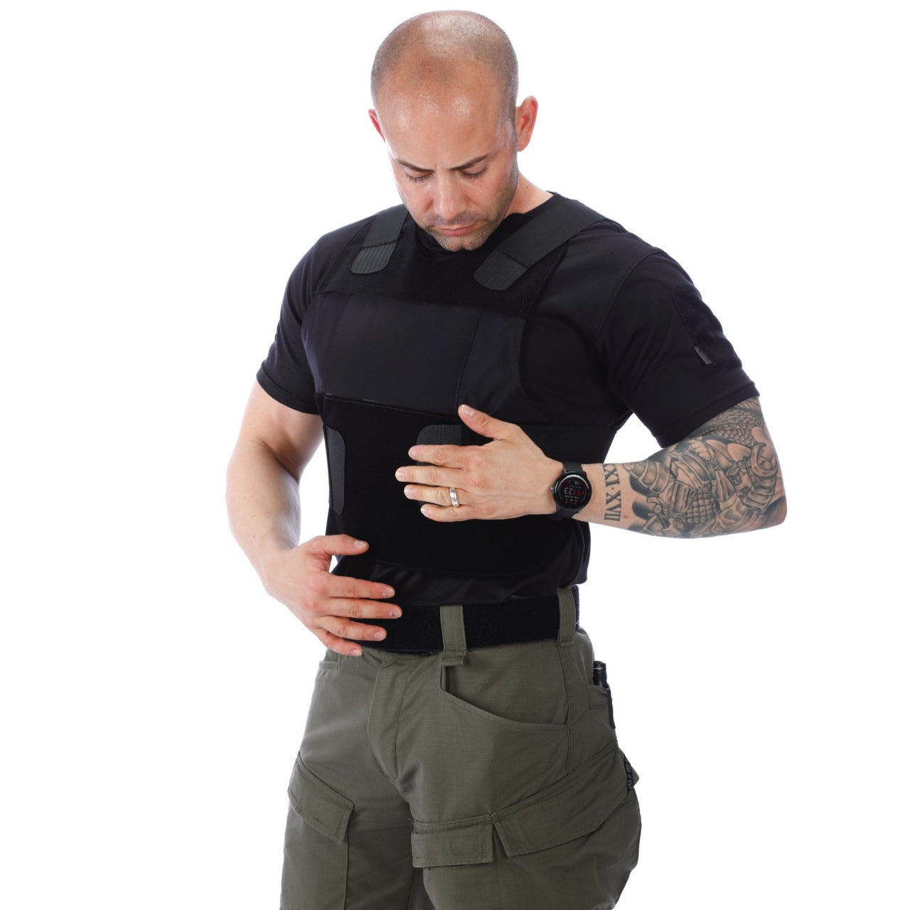A man wearing a Body Armor Direct All American Concealable Enhanced Multi-Threat Vest and green pants.