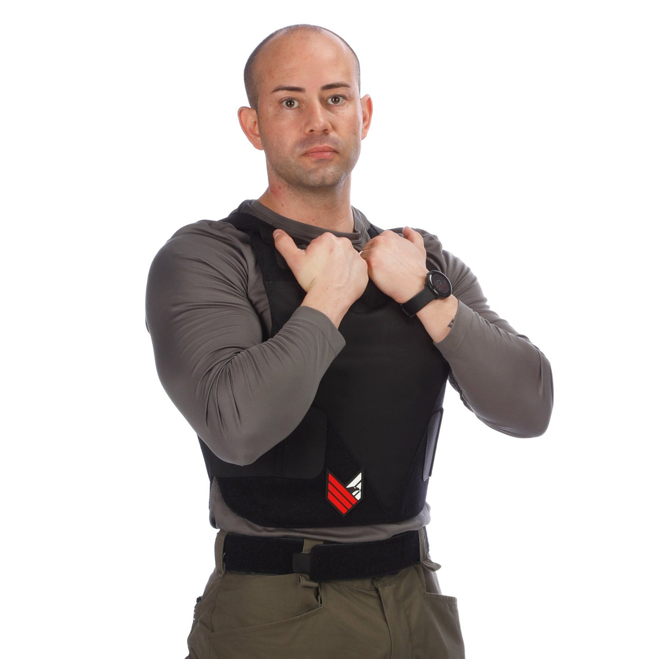A man posing in front of a white background wearing the Body Armor Direct All American Concealable Enhanced Multi-Threat Vest from Body Armor Direct.