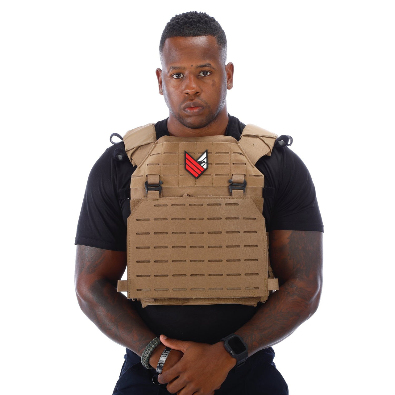 A man wearing a tan Body Armor Direct Expert Plate Carrier, made by Body Armor Direct.