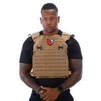 Thumbnail for A man wearing a tan Body Armor Direct Expert Plate Carrier, made by Body Armor Direct.