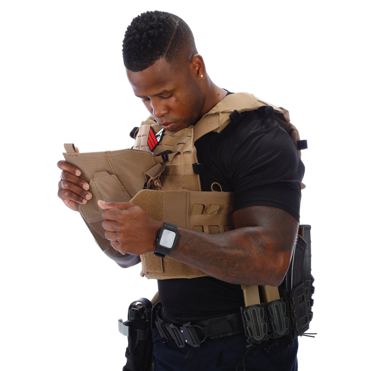 A man is looking at a Body Armor Direct Expert Plate Carrier from Body Armor Direct.