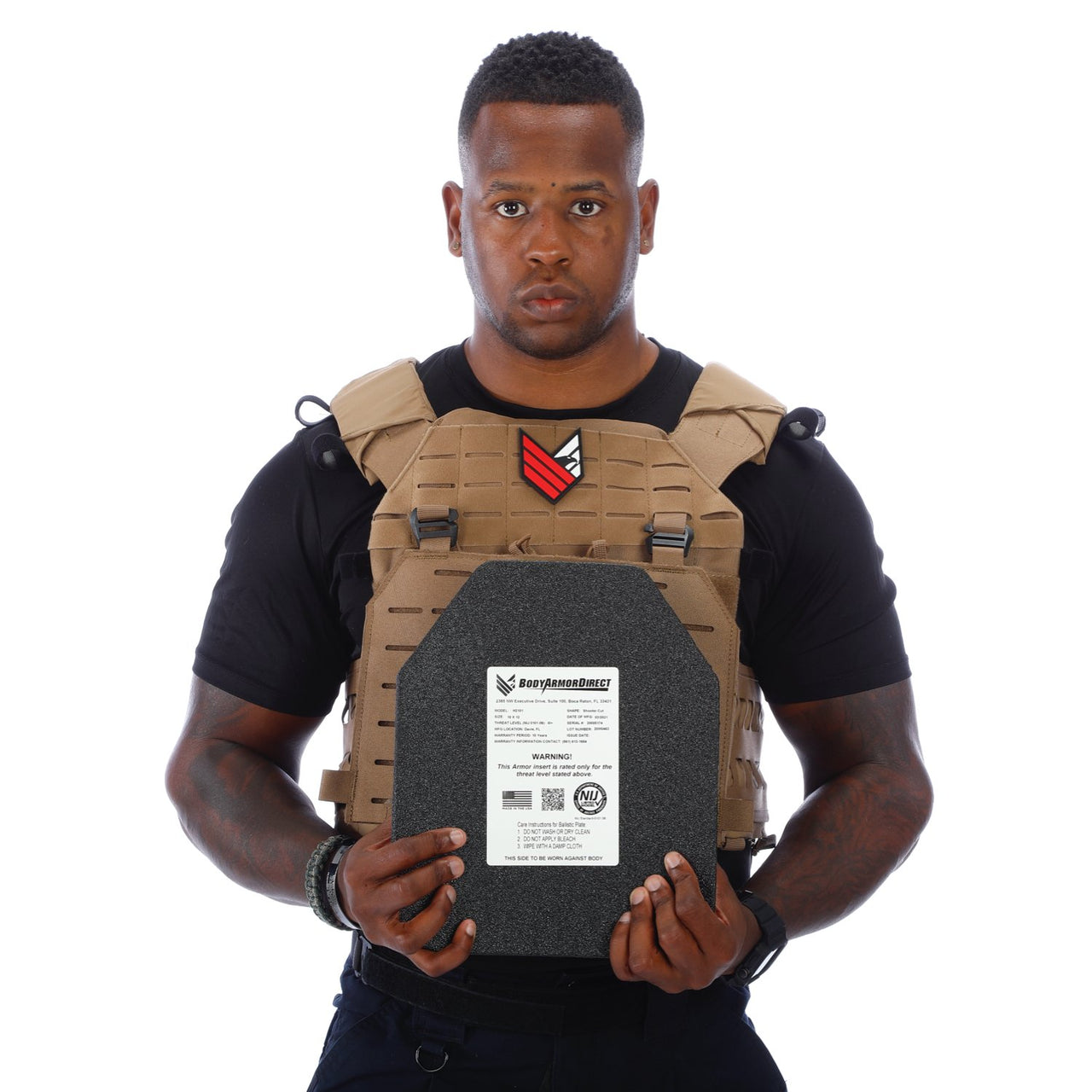 A man holding a Body Armor Direct Expert Plate Carrier in front of a white background.