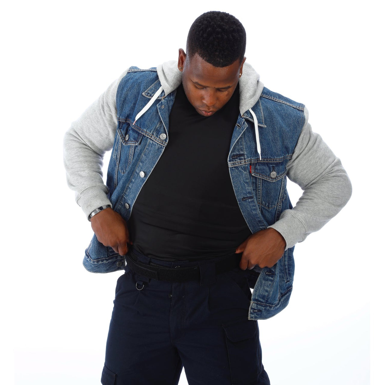 A black man wearing a Body Armor Direct VIP T-Shirt Concealable Enhanced Multi-Threat denim jacket and jeans.