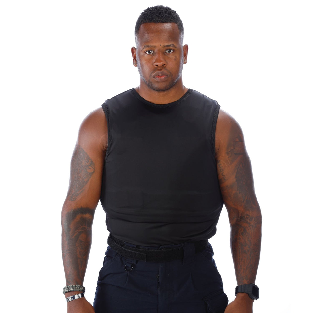 A black man wearing a Body Armor Direct VIP T-Shirt Concealable Enhanced Multi-Threat shirt.