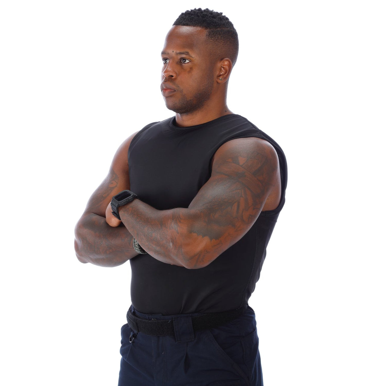 A black man with his arms crossed in front of a white background wearing the Body Armor Direct VIP T-Shirt Concealable Enhanced Multi-Threat from the brand Body Armor Direct.