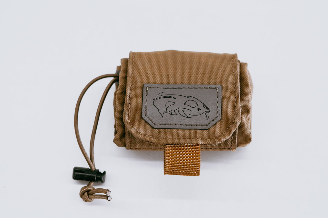 Predator Armor dump pouch with a dark patch featuring a fish logo, closed with a velcro flap and equipped with a drawstring.