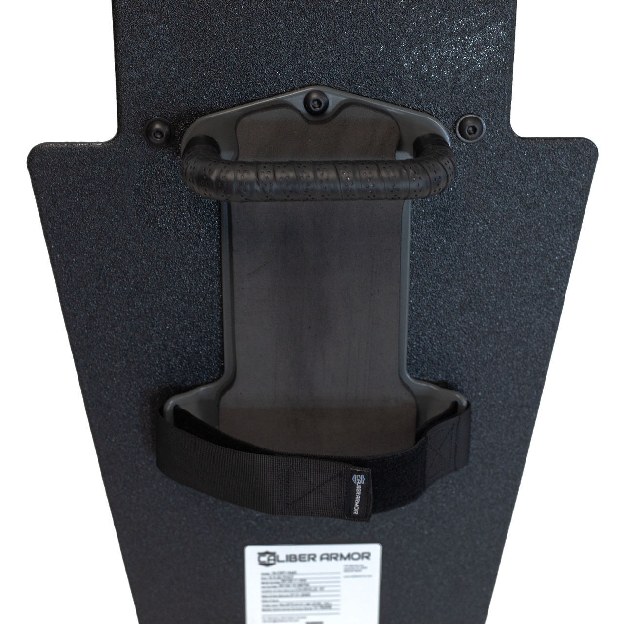 Close up of backside of black 15" x 25" Caliber Armor Pistol rated Level IIIA HG2 Ballistic Shield with handle in the center, padded arm rest & quick release strap on a white background