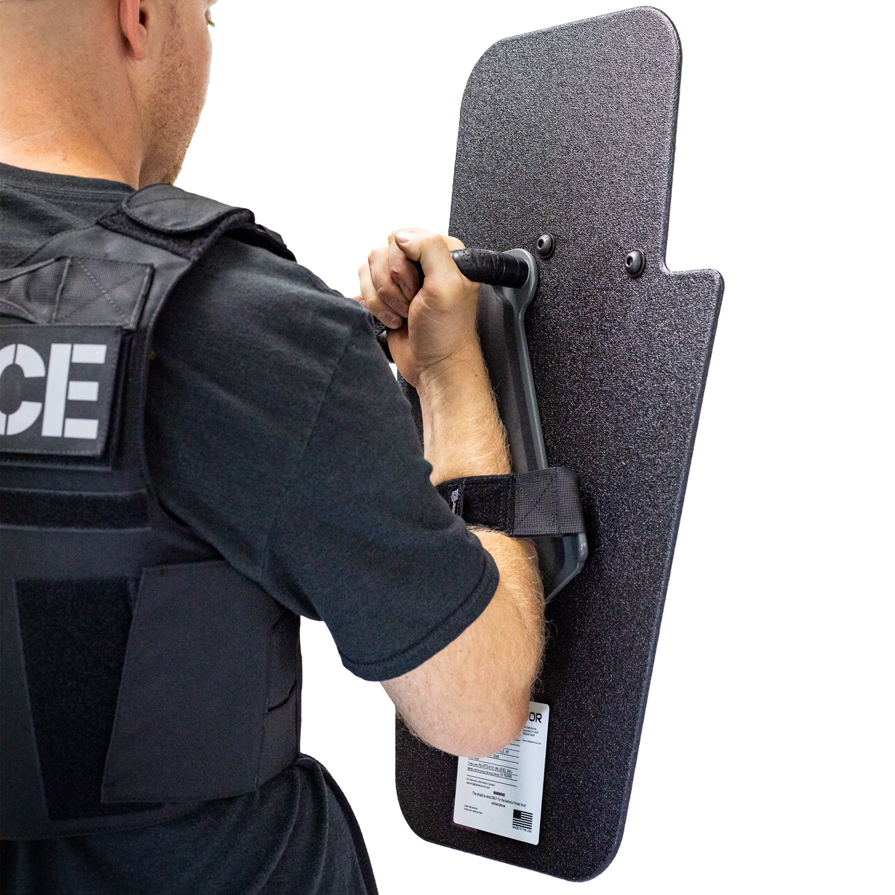 Backside view of man holding black 15" x 25" Caliber Armor Pistol rated Level IIIA HG2 Ballistic Shield with pivoting handle for left handed shooter on a white background