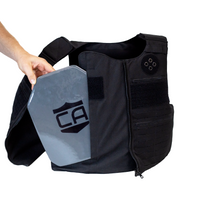 Thumbnail for Black tactical vest with a gray armor plate being side loaded into the front of the vest
