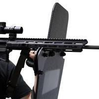 Thumbnail for Close-up of a rifle being supported by a ballistic shield that has a ambidextrious weapon support bracket attached