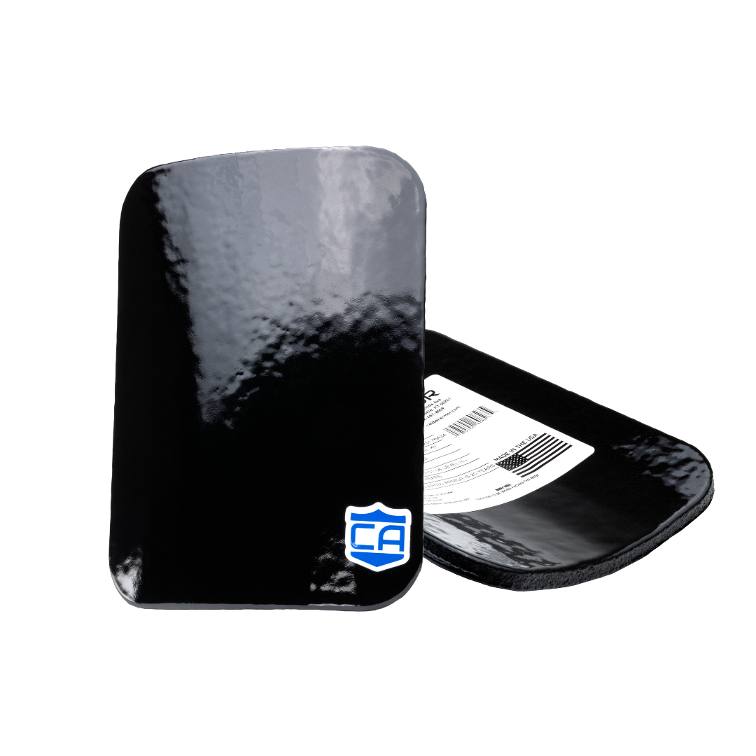 Two black Caliber Armor AR550 III+ Steel Body Armor Side Plates—one upright with a glossy surface and blue-and-white shield logo, the other flat showing the label—highlight their durability and anti-spall coating.