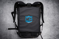 Thumbnail for A black backpack lies flat on a gray surface, featuring a blue 