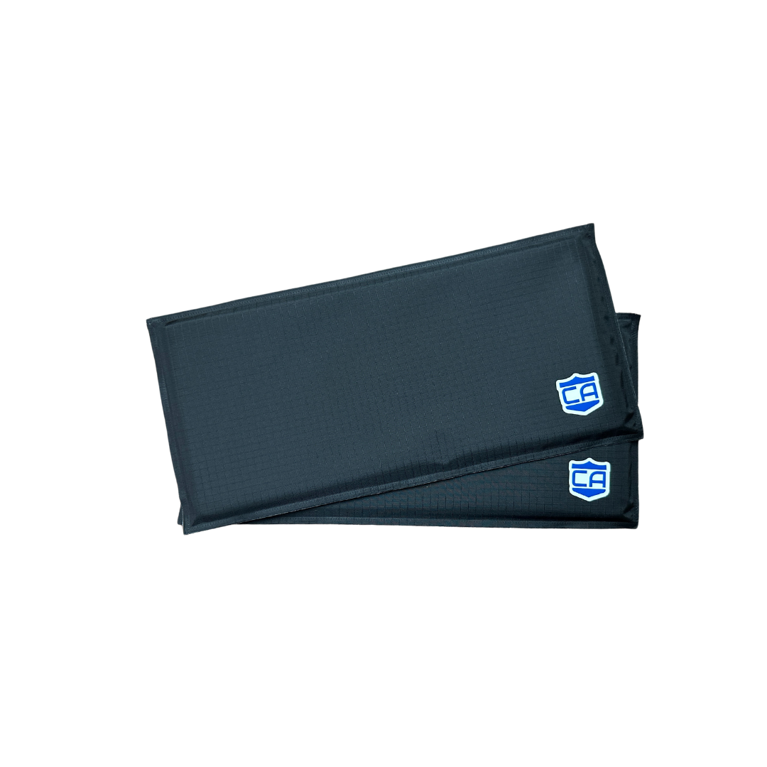 Two stacked black rectangular pads, identified as CaliberX Soft Armor Side Panels by Caliber Armor, featuring blue and white logos in the bottom right corners and placed on a white background.