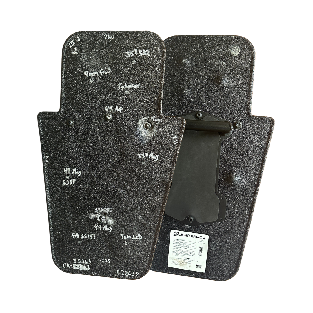 Caliber Armor Level IIIA HG2 Ballistic shield that has been shot for testing purposes, showing no rounds pierced the shield's surface