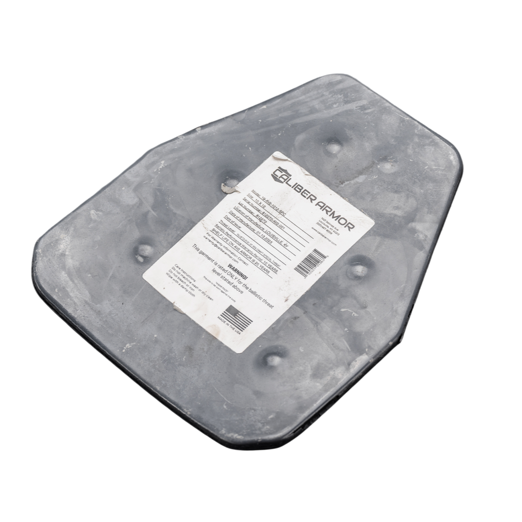 A black, multi-sided AV2 Multi-Curve RF2 NIJ Level III steel body armor plate from Caliber Armor, featuring a white label with product info in the center.