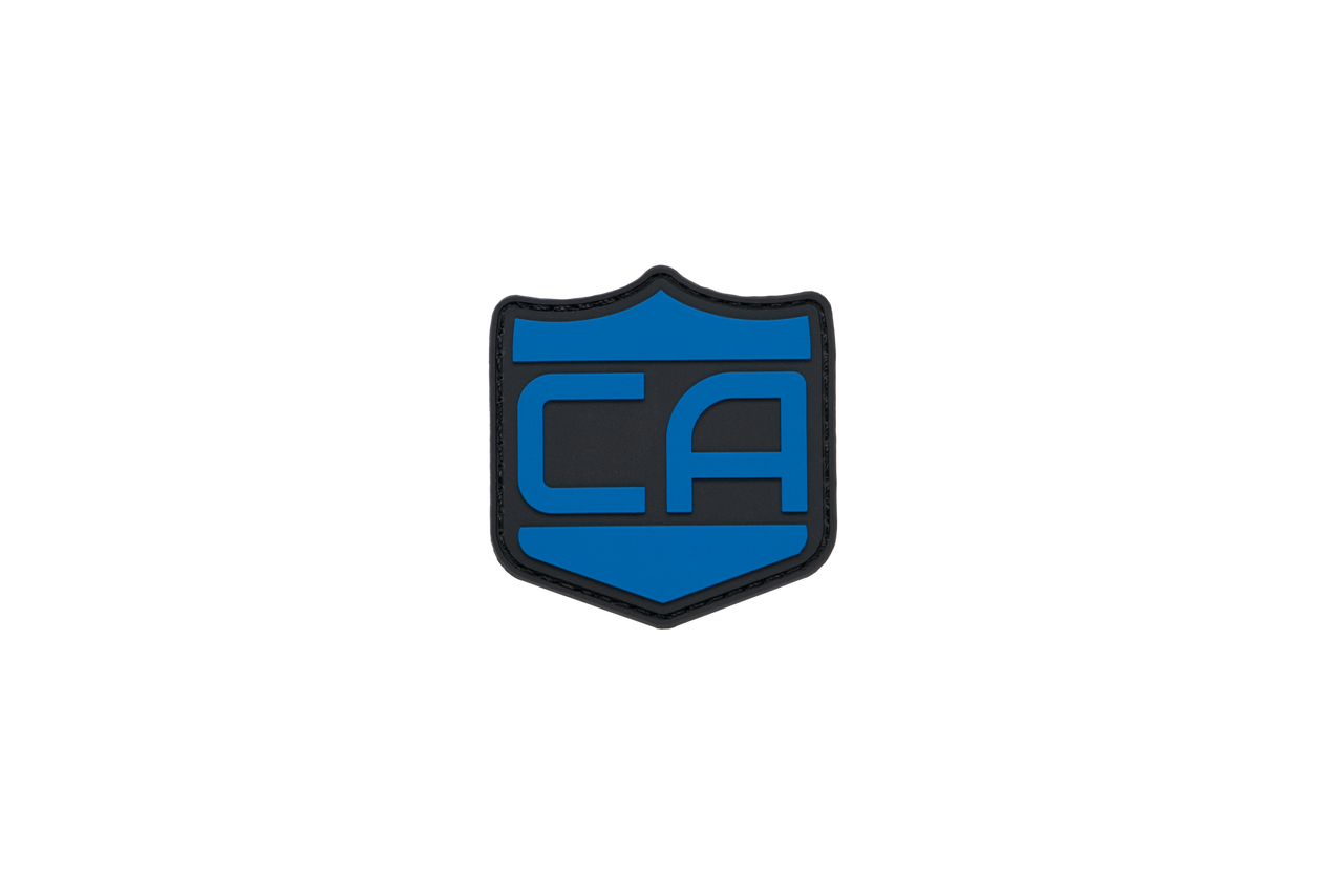 The Caliber Armor Caliber PVC Morale Patch features a blue and black shield with bold "CA" letters on white—perfect for upgrading your tactical gear with its eye-catching Guardian Shield design.