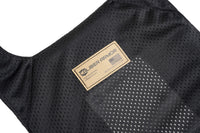 Thumbnail for Close-up of the Caliber Armor CaliberX IIIA Gray Man Concealable Package with black mesh fabric, tan brand label, American flag, and a rectangular perforated section on the carrier.