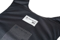 Thumbnail for Close-up of a black mesh fabric Caliber Covert Concealable Vest by Caliber Armor, featuring a rectangular label stitched on the front.