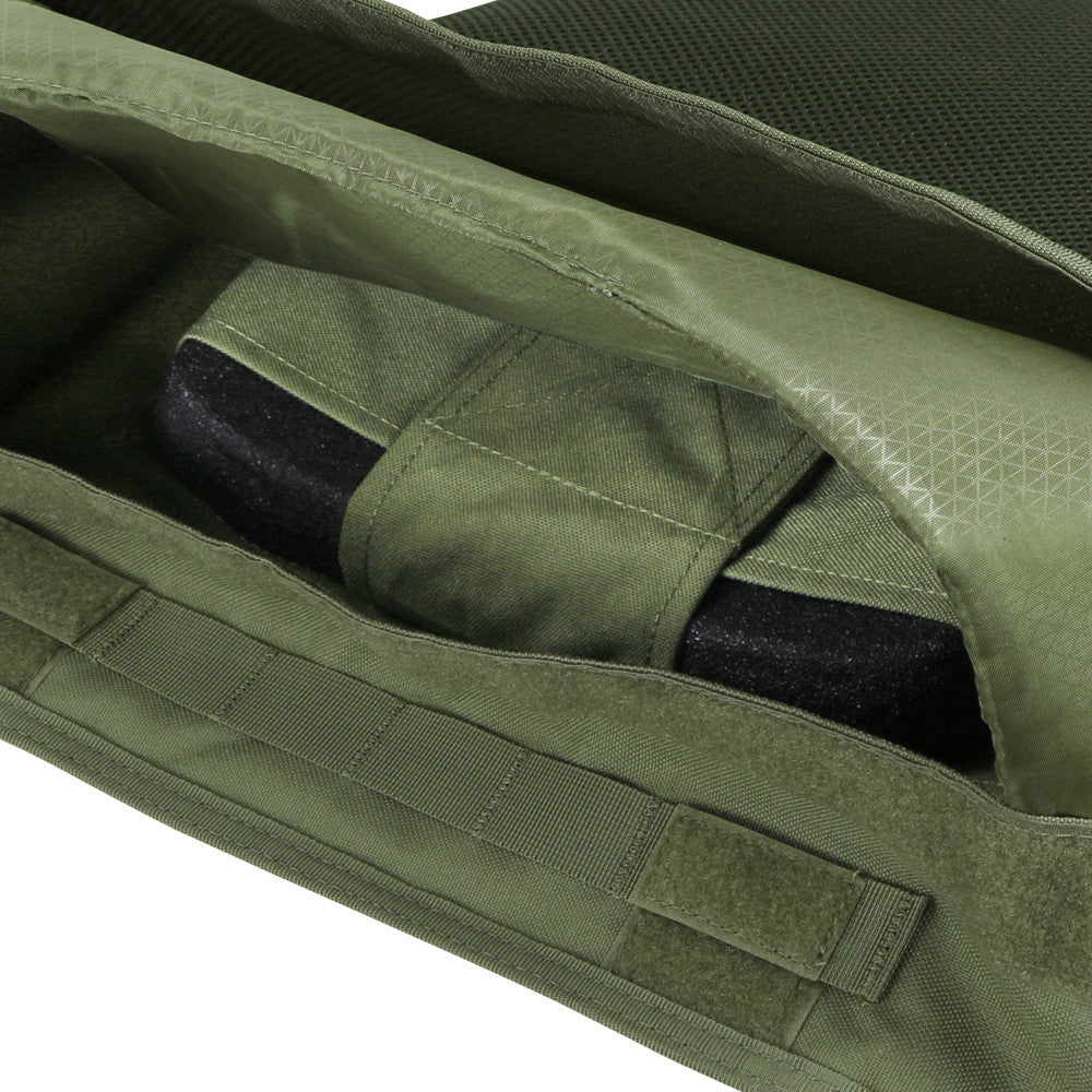 Close-up of an open green vest pocket reveals a black hard armor plate, perfect for use with the Caliber Armor EXO PLATE CARRIER GEN II or similar body armor setups.