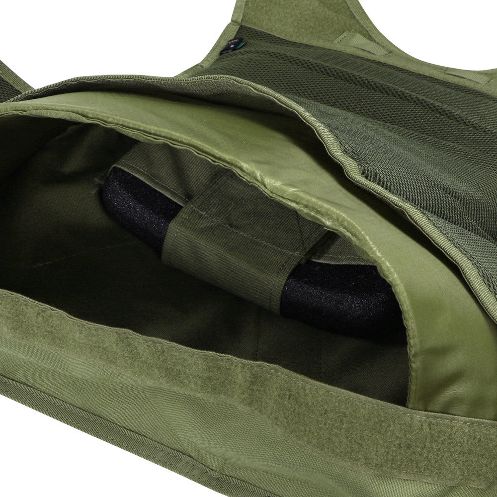 Close-up of an olive green pocket on the Caliber Armor EXO PLATE CARRIER GEN II, with a Velcro flap partially open to show an interior strap and black hard armor plate.