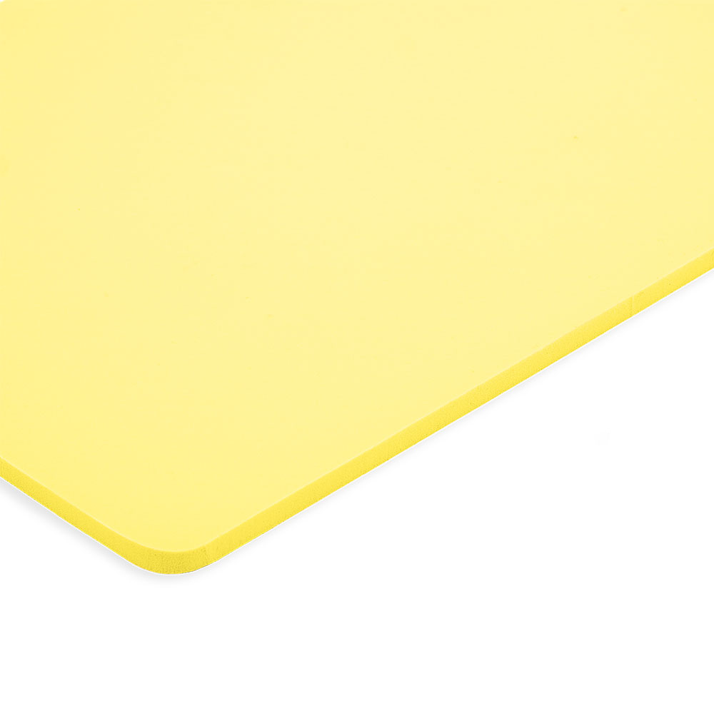 A close-up of the corner of a rectangular yellow cutting board with rounded edges on a white background, featuring superior impact absorption inspired by Caliber Armor's Extreme Impact Trauma Pad - Side Pads.