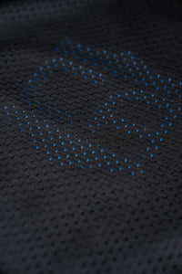 Thumbnail for Close-up of the Gray Man Concealable Carrier from Caliber Armor, featuring black perforated fabric with a blue hexagonal dotted pattern—ideal for discreet wear or soft armor panels.