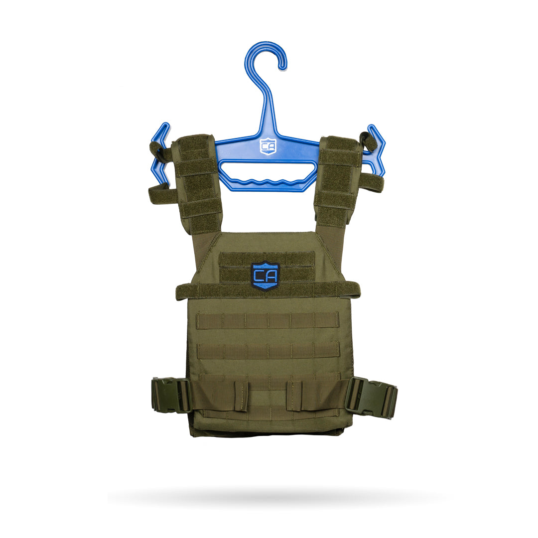 An olive green tactical vest with adjustable straps is shown on a Caliber Armor Tough Hook, a blue heavy-duty hanger, against a white background.
