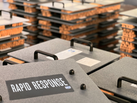 Thumbnail for Close-up of several gray Caliber Armor Rapid Response Shield - Ultra Series cases labeled 