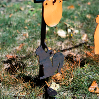 Thumbnail for A Double Tap Industries Hook Spiked Ground Stand featuring a metal squirrel silhouette is set up on grass with fallen leaves and orange decor in the background.