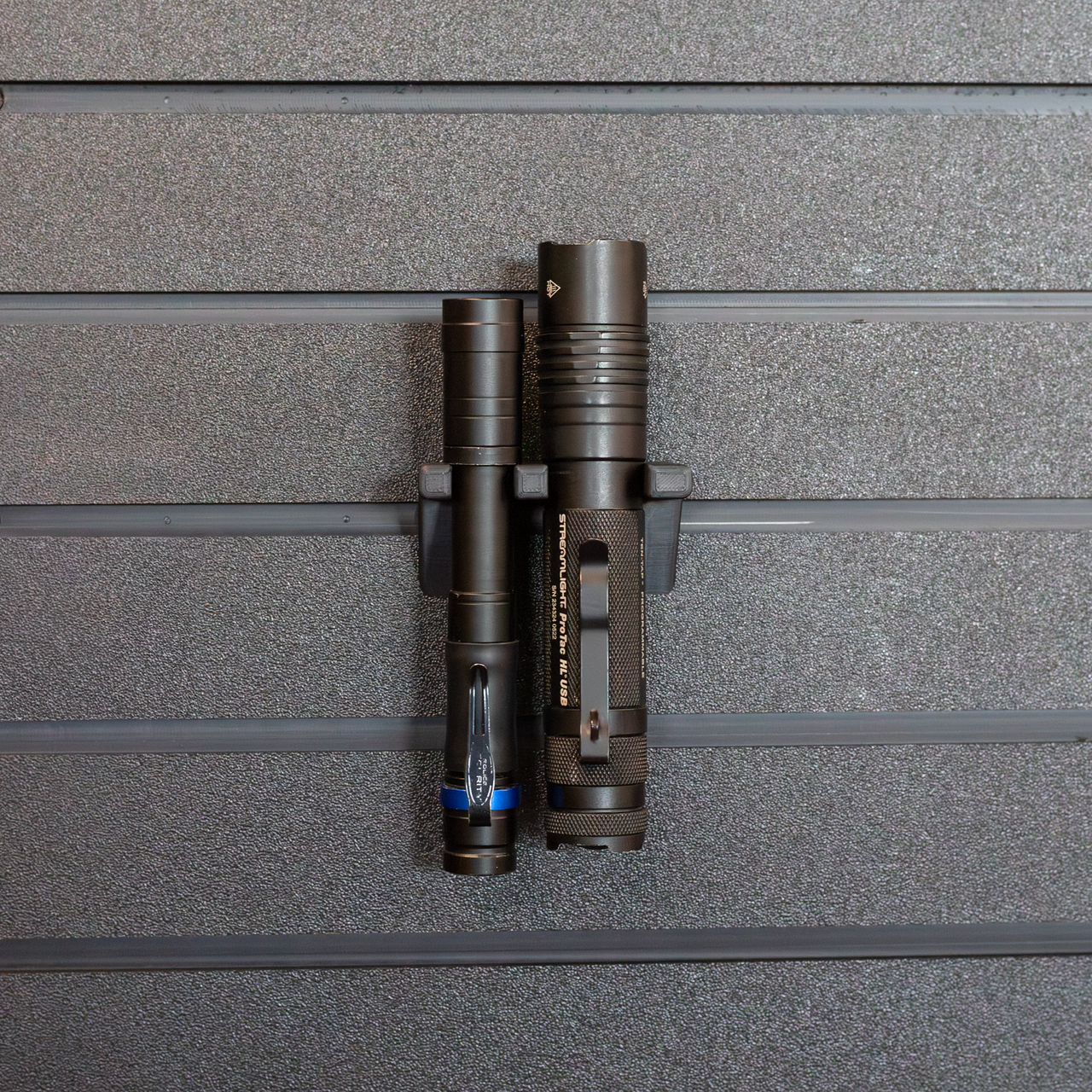 Tactical flashlight wall hanging mount, holding 2 flashlights shown mounted from our Assault Wall tactical slat wall