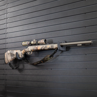 Thumbnail for Camo muzzle loader with scope mounted on two hooks that have been set at varrying heights to properly support the barrel and butt stock of the gun, hooks are mounted on the Assault Wall slat wall panel system