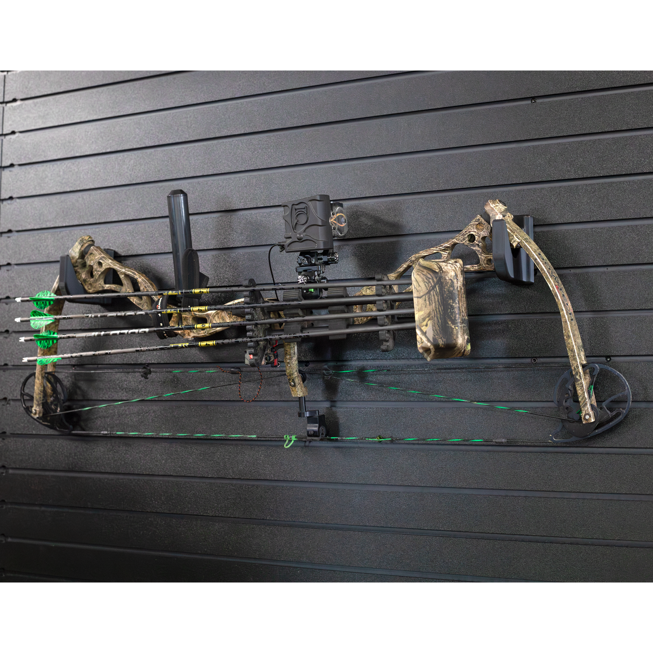Camo compound bow horizontally mounted from two hooks and are hanging off of the Assault Wall slat wall panels