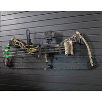 Thumbnail for Camo compound bow horizontally mounted from two hooks and are hanging off of the Assault Wall slat wall panels