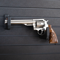 Thumbnail for Large revolver pistol mounted on two hooks that have been set at varrying heights to properly support the barrel and grip of the gun, hooks are mounted on the Assault Wall slat wall panel system