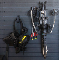 Thumbnail for Compound bow and loaded law enforcement duty belt both hung from black plastic hooks on slat wall