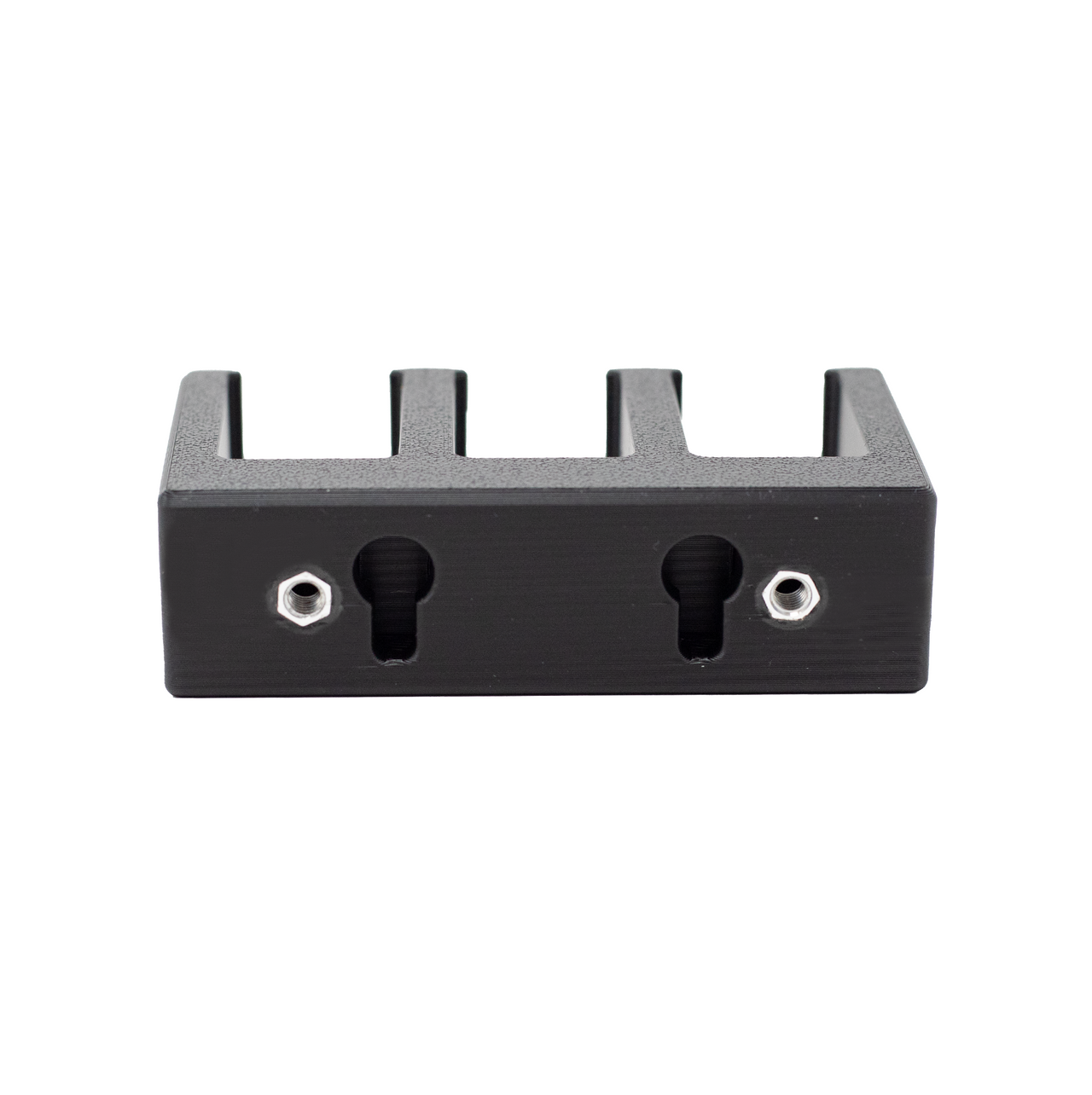 Backside of black pistol magazine hanger showing that it the slots that can be used to directly mount the holder to a wall as well as where the slat wall hardware goes to enable mounting directly onto Assault Wall slat walls