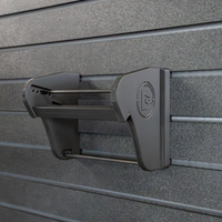 Thumbnail for Assault Wall Universal Mag Holder with doublet tap logo with adjustable tension, shown empty mounted to a black Assault Wall panel, highlighting the adjustable slot options that the carbon fiber rod rests in