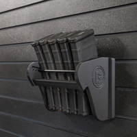 Thumbnail for Assault Wall Universal Mag Holder with doublet tap logo with adjustable tension, shown loaded with PMAG rifle magazines mounted to a black Assault Wall panel, highlighting the adjustable slot options that the carbon fiber rod rests in