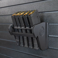 Thumbnail for Assault Wall Universal Mag Holder with doublet tap logo with adjustable tension, shown loaded with loaded rifle mags & mounted to a black Assault Wall panel, highlighting the adjustable slot options that the carbon fiber rod rests in