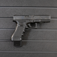 Thumbnail for Right facing black plastic magazine mounted 40 cal pistol hanger installed on Assault Wall Tactical slat wall