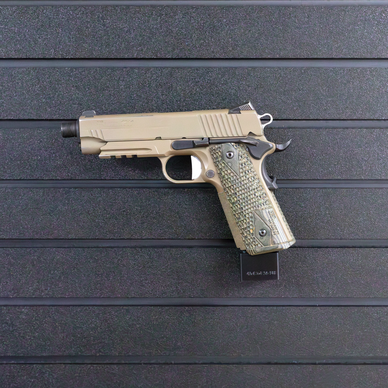 Left facing black plastic magazine mounted 45 Cal pistol hanger installed on Assault Wall Tactical slat wall