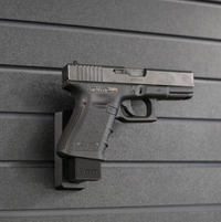 Thumbnail for Right facing black plastic magazine mounted 9mm pistol hanger installed on Assault Wall Tactical slat wall