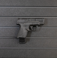 Thumbnail for Right facing black plastic magazine mounted 9mm single stack pistol hanger installed on Assault Wall Tactical slat wall