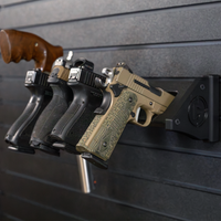 Thumbnail for Black plastic five pistol storage mount loaded with smith and weston, revolver and glock pistols , all five pistols are resting in equally spaced slots, some with the pistol grip facing out and outhers with the grip facing up, mount is hanging from black tactical slat wall